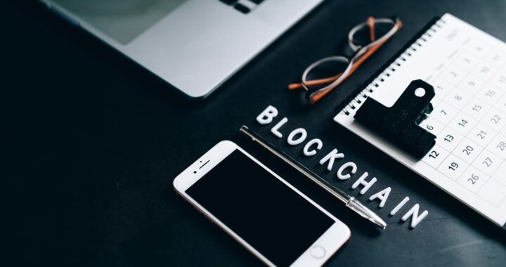 Free Flat lay of a modern digital workspace with blockchain theme, featuring a smartphone and calendar. Stock Photo